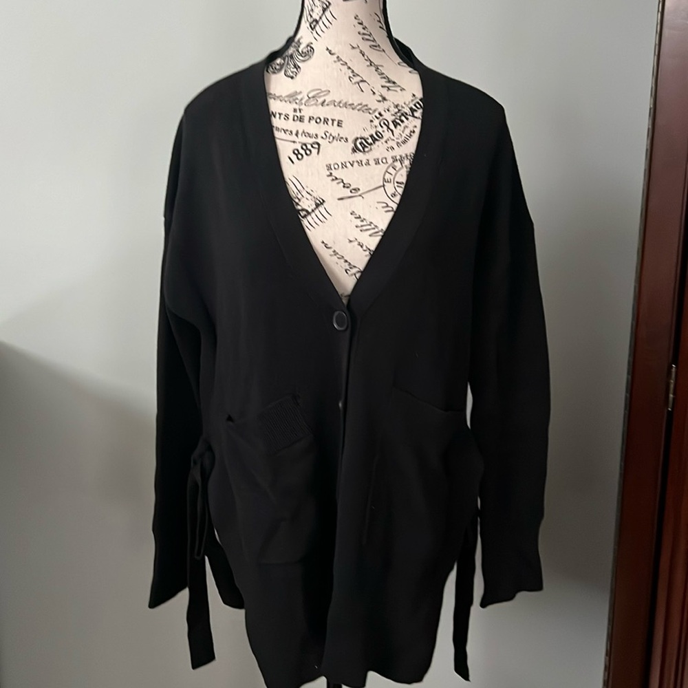 Black cardigan with 2 slits on both sides that you can tie hits below the waist
